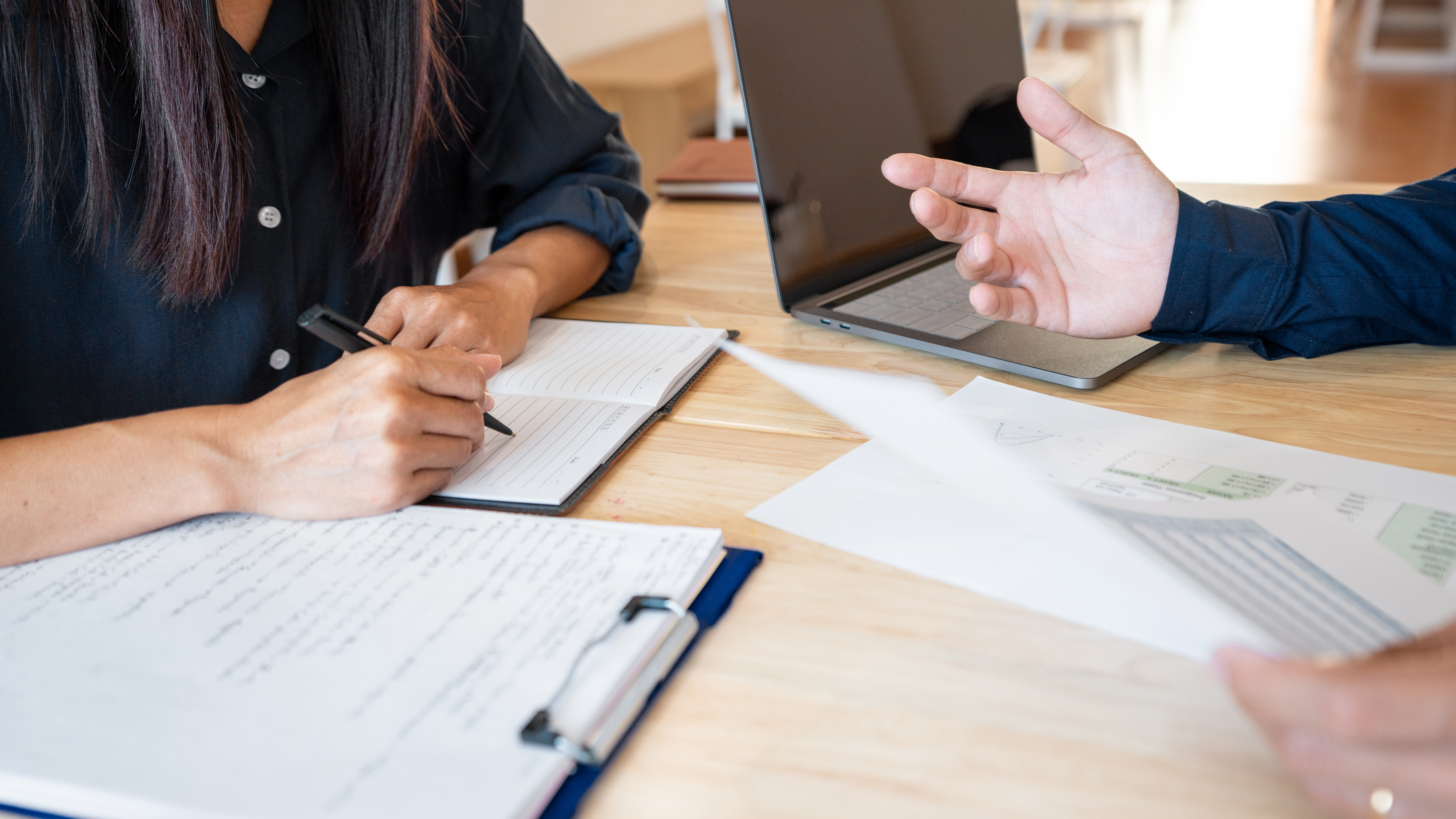 Two people reviewing documents together.